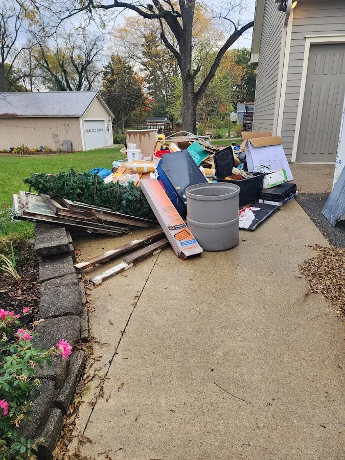 Dumpster being loaded with debris for Estate Cleanout Dumpster Rental in Little Flock